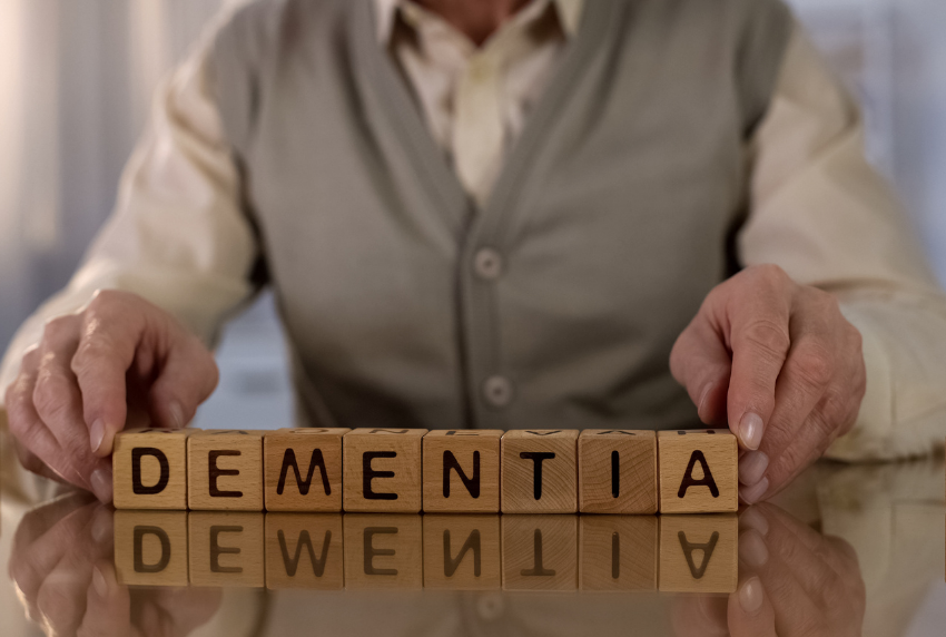 Blocks that read dementia in between hands.