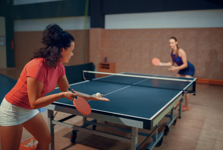 Two people playing ping-pong. 