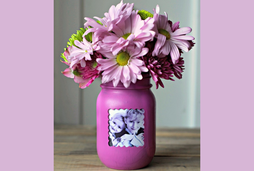 Mason jar with photo and spring flowers. 