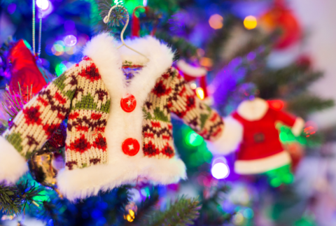 Ugly sweater ornament hanging from a Christmas tree,