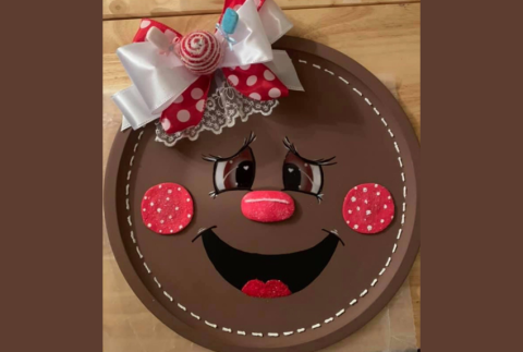 Top view of gingerbread girl face on a plate.