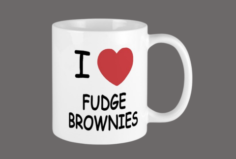 Mug with words on it reading,  I (heart image) fudge brownies.