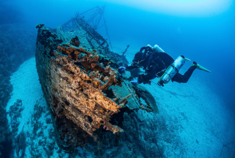 Ship wreck with a scuba diver.