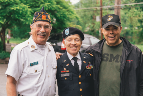Three men side by side in veteran uniforms.