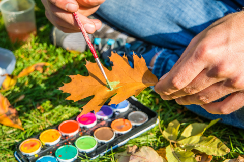 A person painting on a leaf