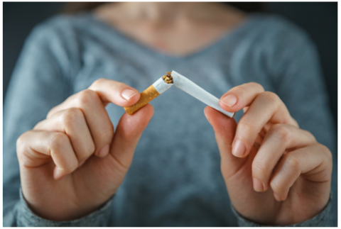 Woman breaking cigarette with two hands