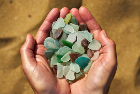 Bunch of sea glass in hands.