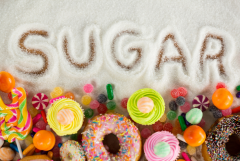 Different types of sugary food on the bottom with the word sugar written on top. 