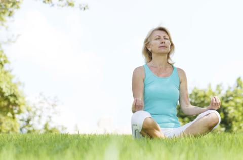 Woman sitting in lotus position meditating