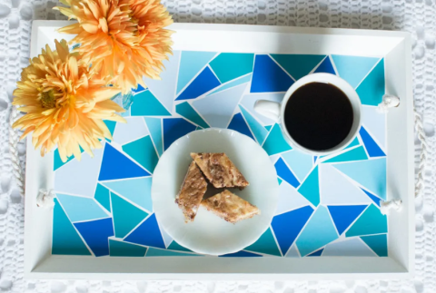 Top view of coffee tray with flowers, cookies and cup of coffee. 