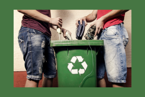 Side view of two people dumping electronics in recycle bin. 