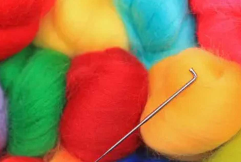 Picture of yarn skeins and a needle