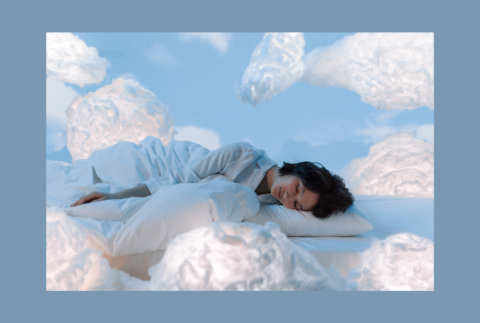 Person laying down with clouds all around. 