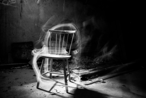 Rocking chair with smoke around it. 