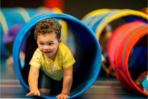 Child going through play tunnel