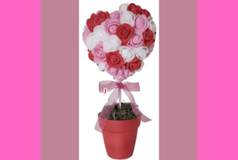 Pot with a heart shape made out of roses on top on a stick. 