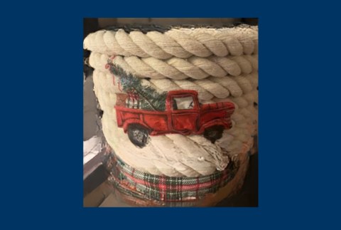 Basket wrapped in jute and decorated with red truck. 