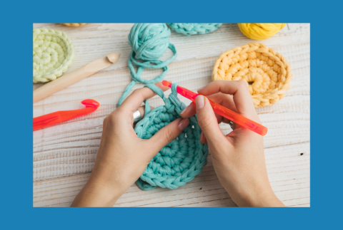 Top view of hands crocheting.  