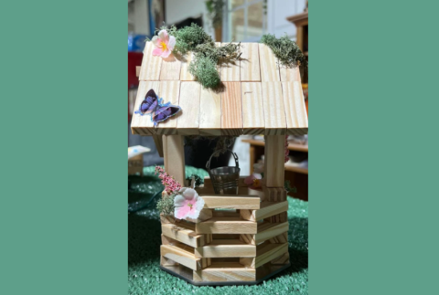 Wishing well made out of wooden blocks. 