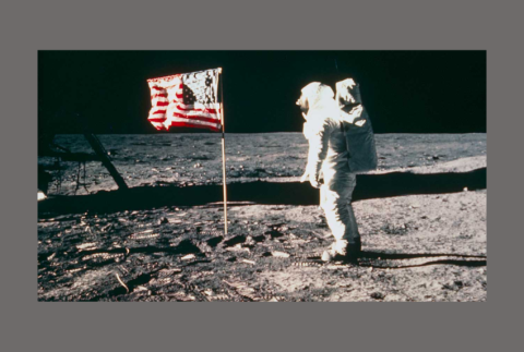 Man on the moon with American flag. 