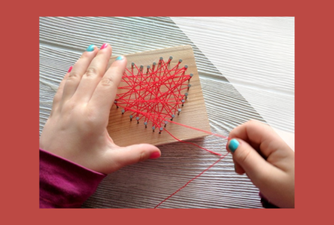 Top view of string art in the shape of a heart. 