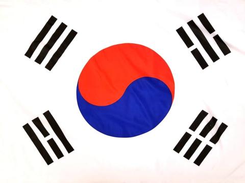 Flag of South Korea Ying Yang which is blue and read and four sets of three stripes around the Ying Yang.