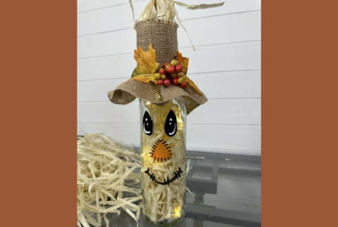 Scarecrow painted on a wine bottle. 