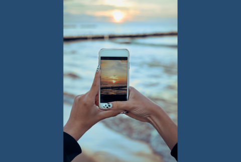 Smartphone taking photo of sunset. 