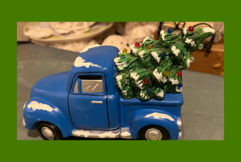 Ceramic blue truck with a Christmas tree in the back. 