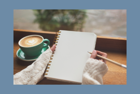 Journal with coffee  to the side. 