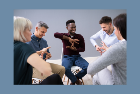 Group of people learning sign language. 