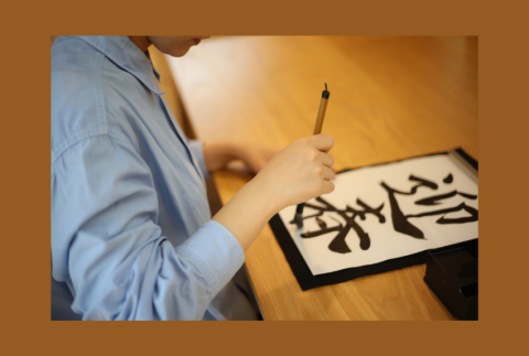 Top view of a person writing calligraphy. 