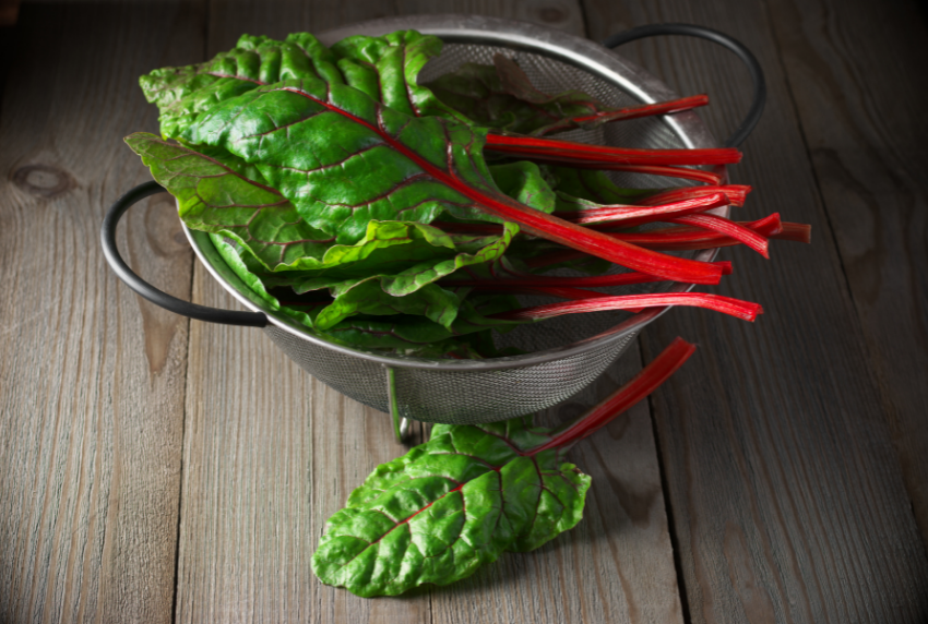 Colander with swiss chard on top. 