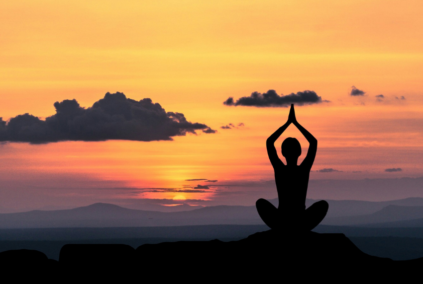 Sunset with person meditating. 