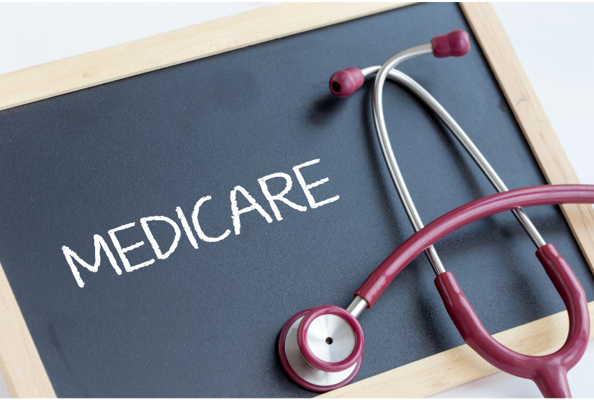 chalkboard that reads , Medicare. Stethoscope lying on top of chalk board.