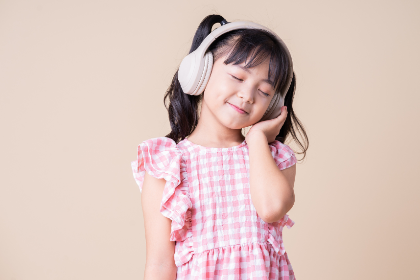 a child listening to something with headphones