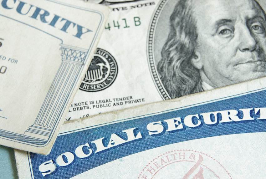 Social security card on top of money.