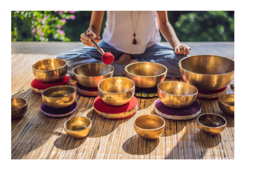 Woman playing sound bowls