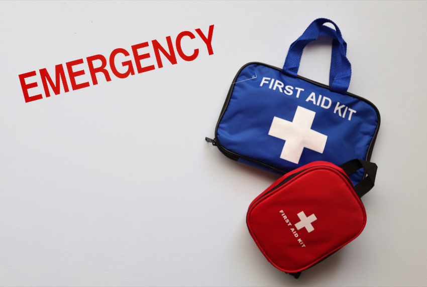 First aid kit with the words emergency in the corner.