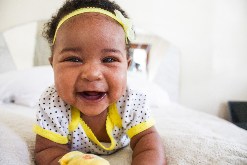 Baby laying down laughing