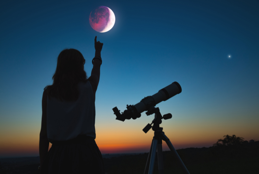 Person pointing to the sky during an eclipse. 