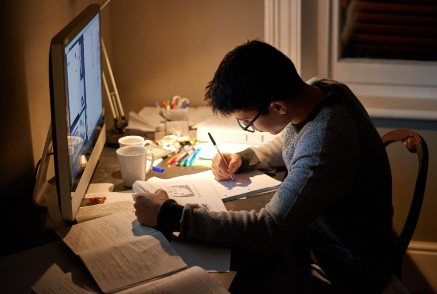 Student in front of a computer doing work. 