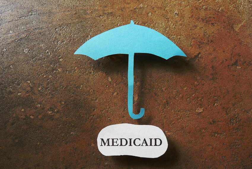 Umbrella with the word Medicaid underneath. 