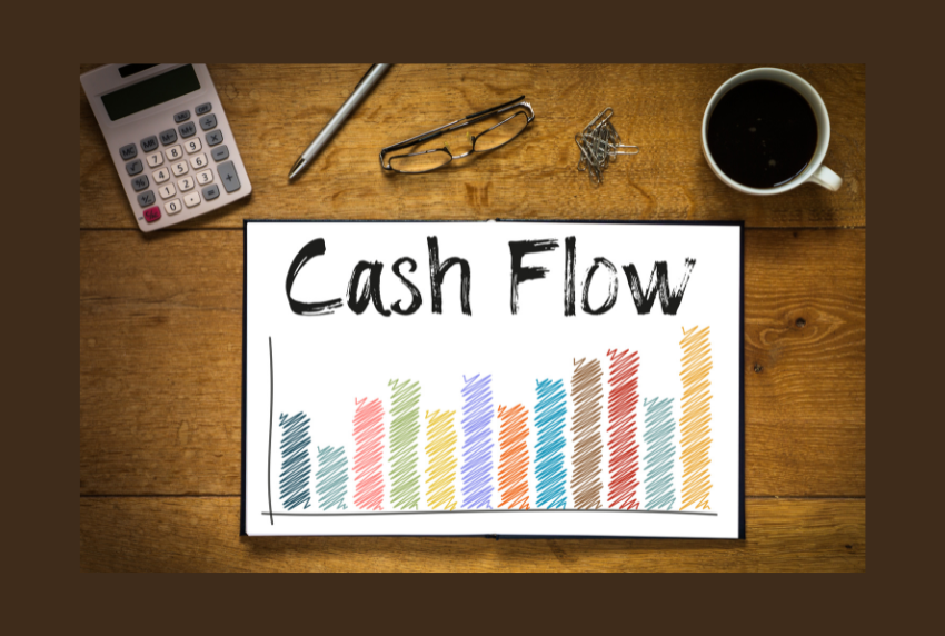 Top view of cash flow chart, calculator, pen and cup of coffee. 