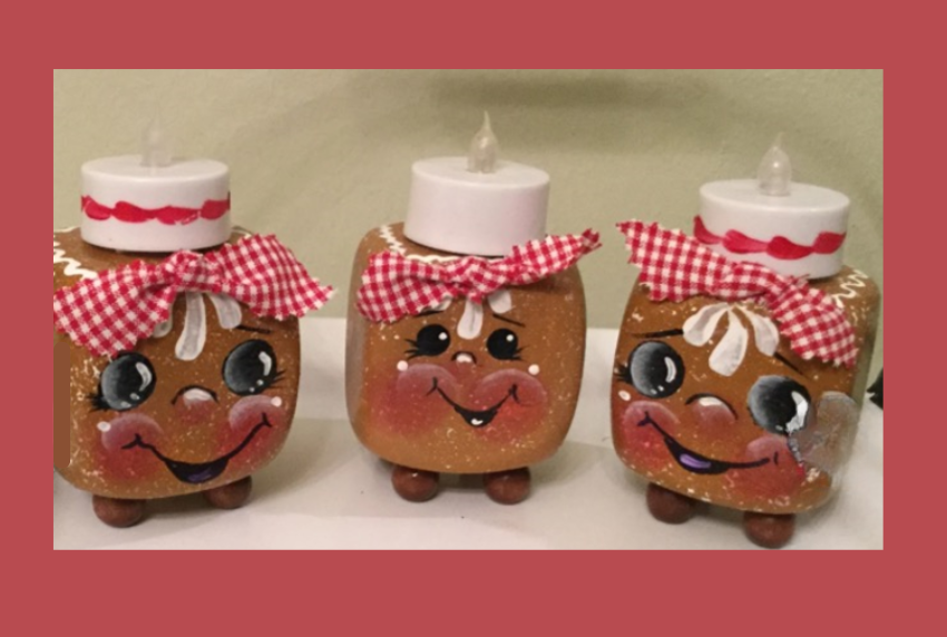 Three gingerbread blocks with tea light candles on top.