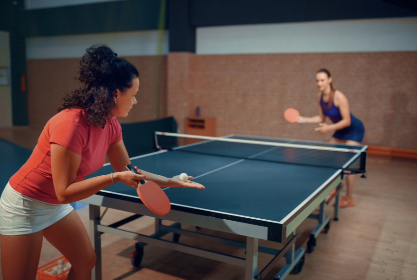 Two people playing ping-pong.