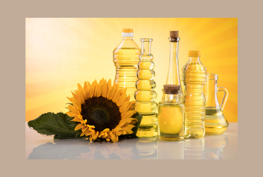 Sunflower next to bottles of oil.