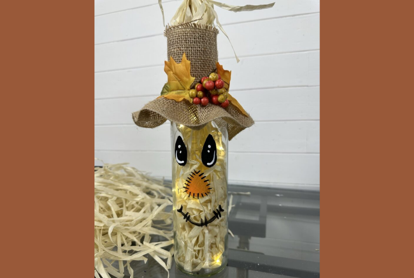 Scarecrow painted on a wine bottle. 