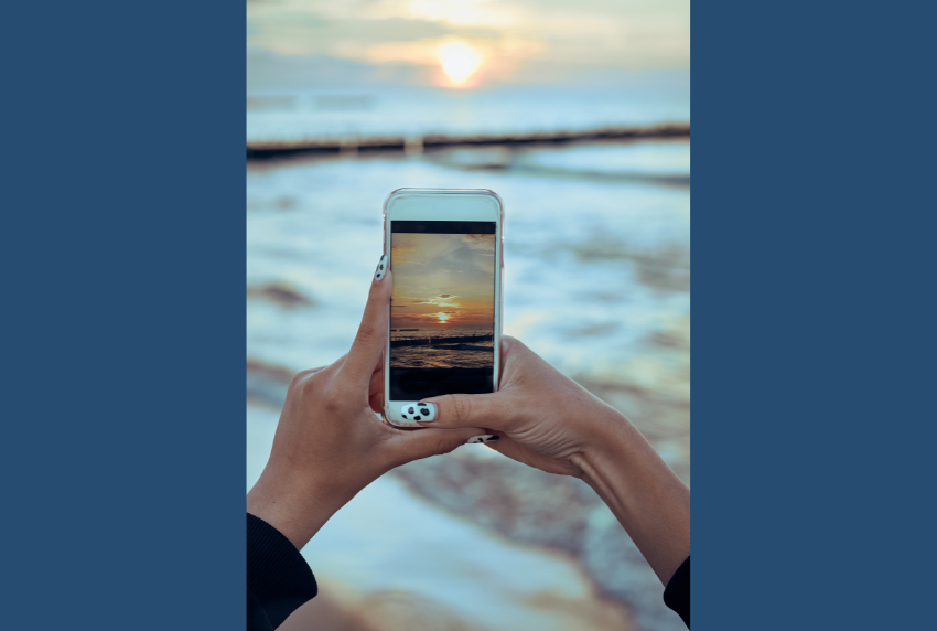 Smartphone taking photo of sunset. 