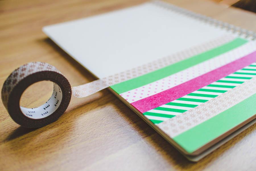 Picture of a notebook and washi tape being put on it